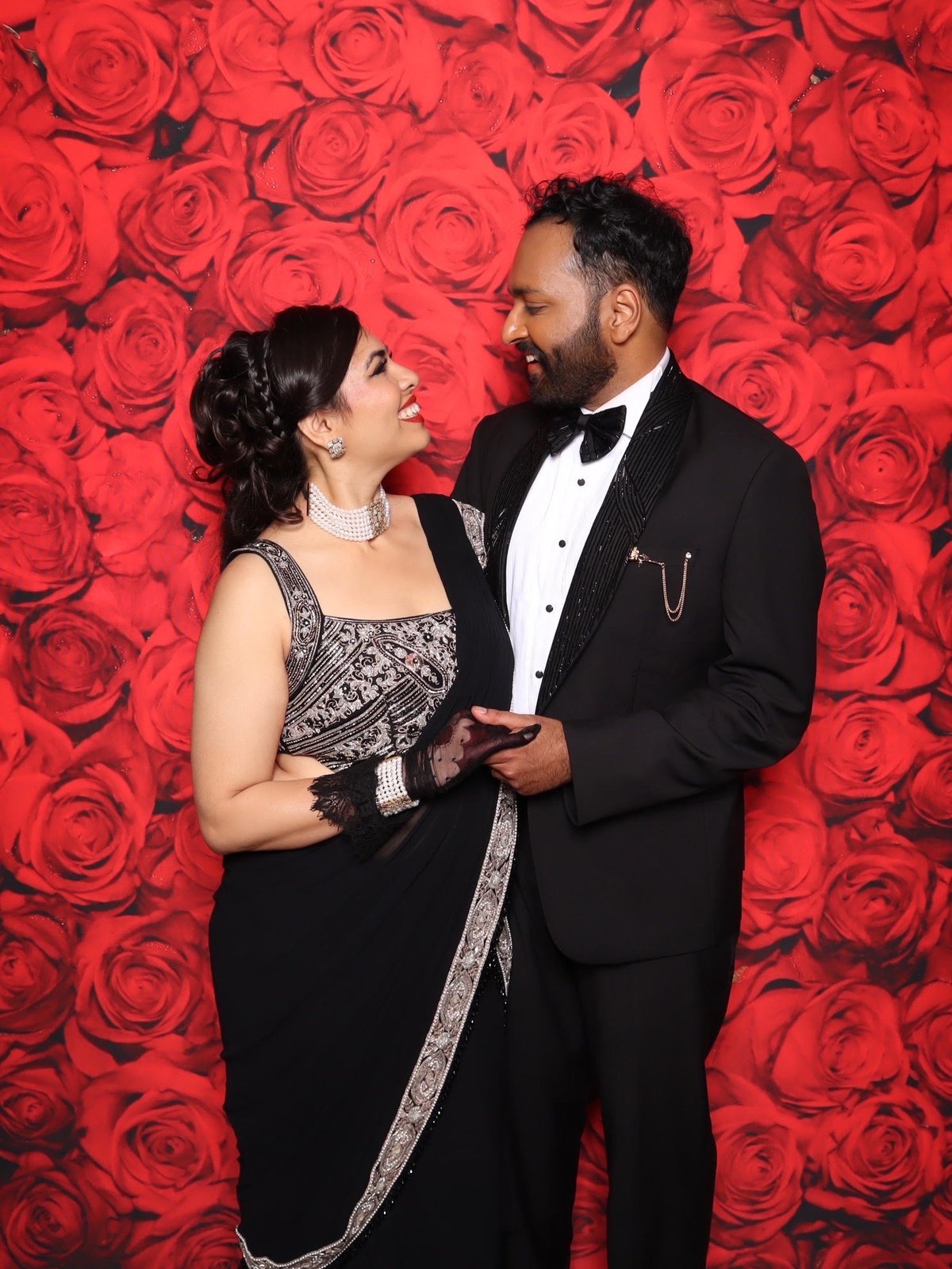 Couple at the red rose wall
