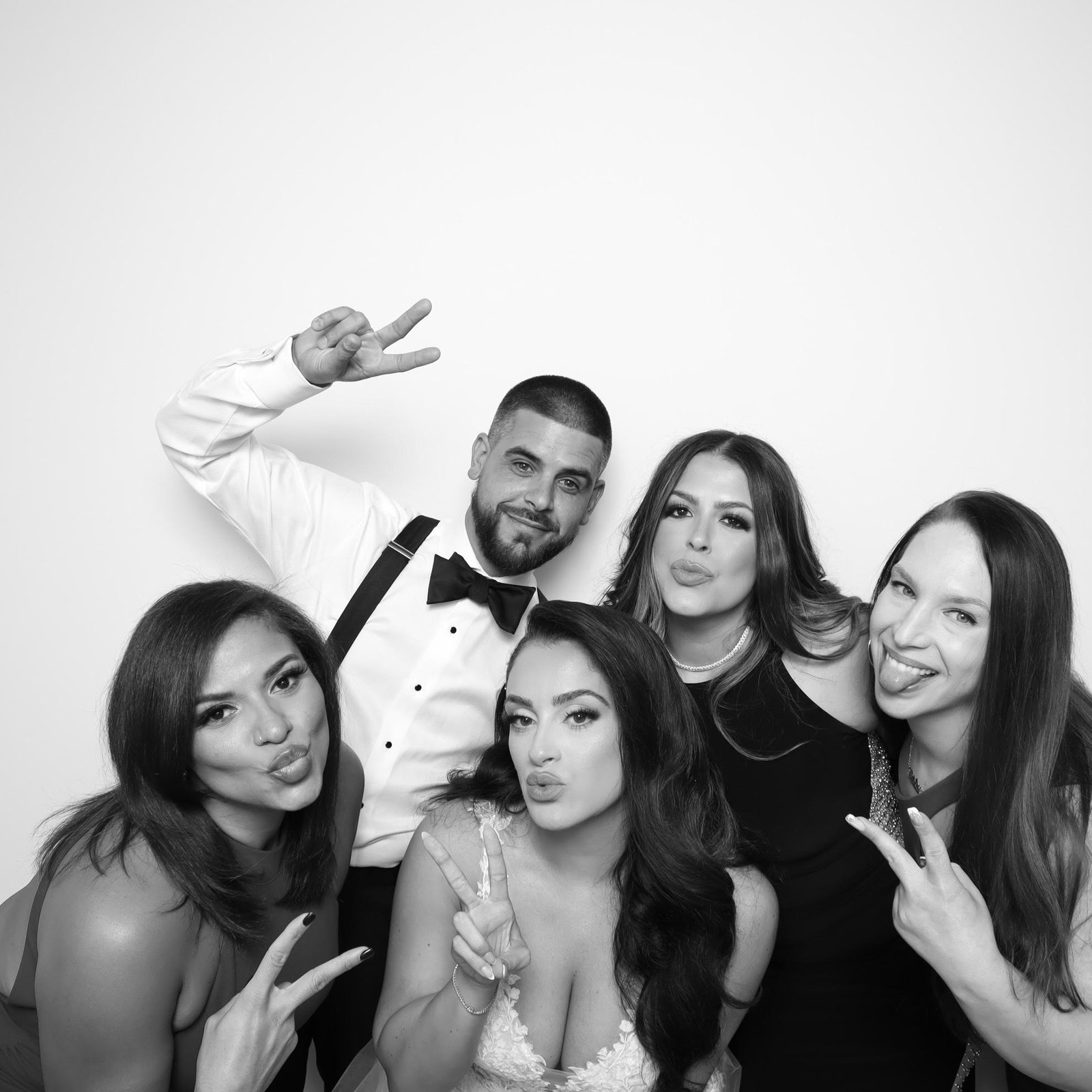 Wedding party having fun in the booth