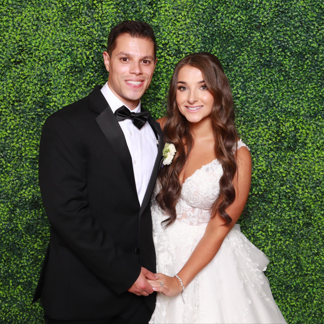 Couple at the greenery wall