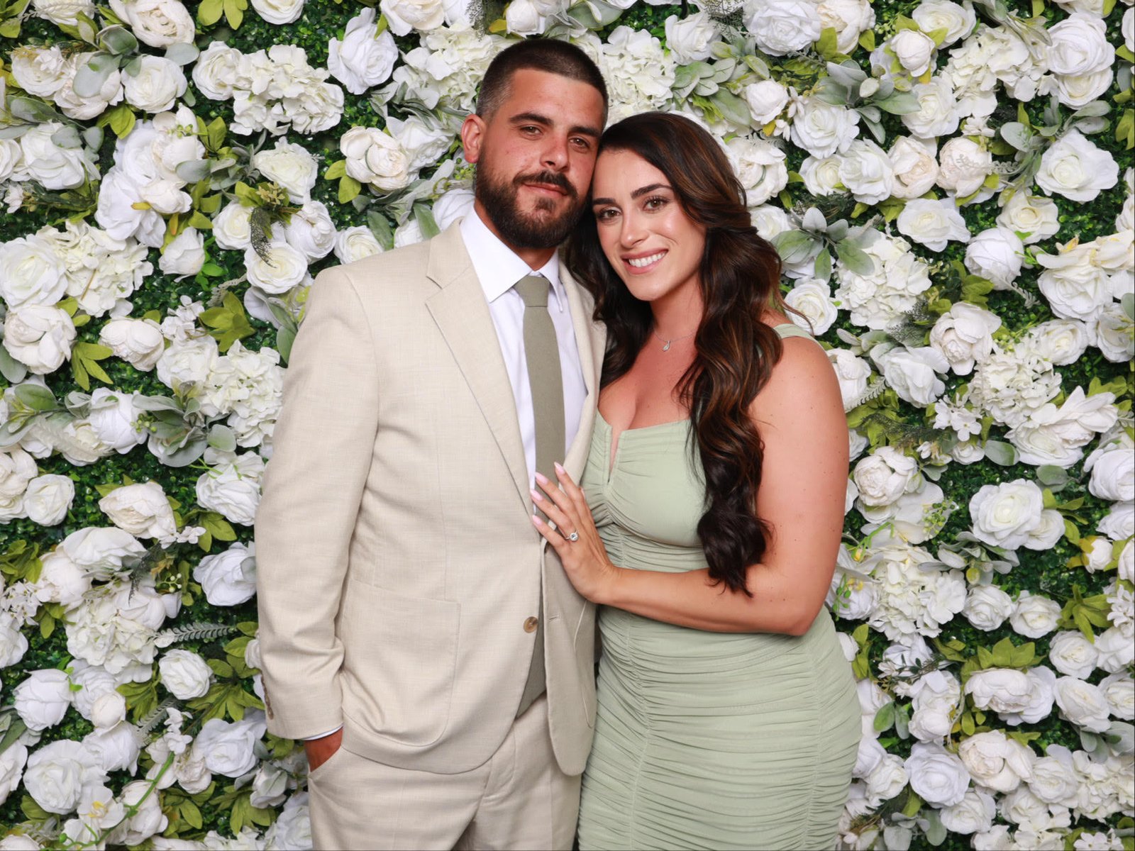 Couple at the white flower wall