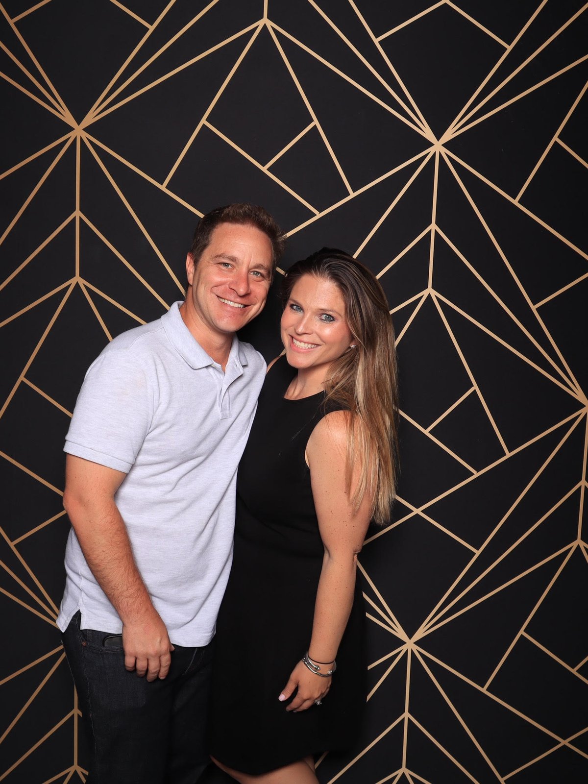 Couple at the black and gold backdrop